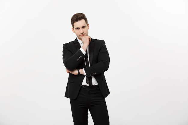 Young handsome man in black suit and glasses looking at copy-space smiling,thinking or dreaming isolated over white background