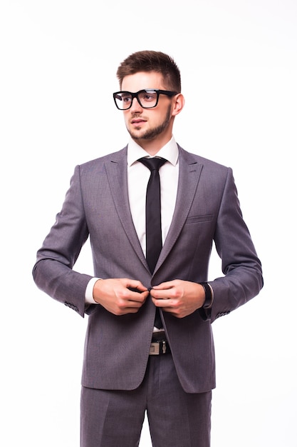 Young handsome man in black suit and glasses smiling isolated on white background