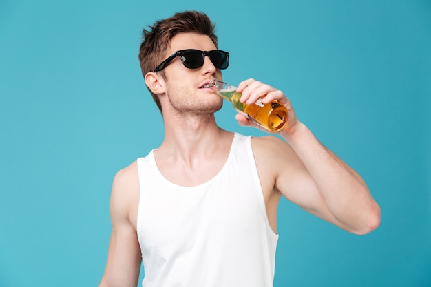 Young handsome man drinking beer