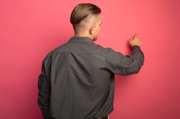 Young handsome man in grey shirt 