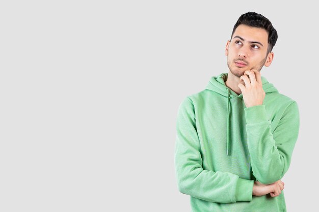 young handsome man in hoodie standing and posing