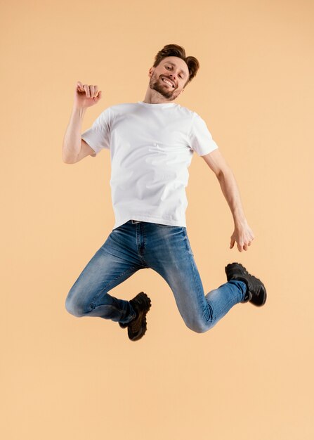 Young handsome man jumping