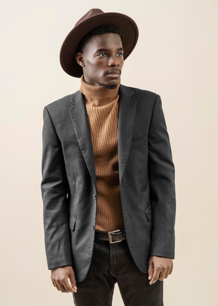 Free photo young handsome man posing with hat