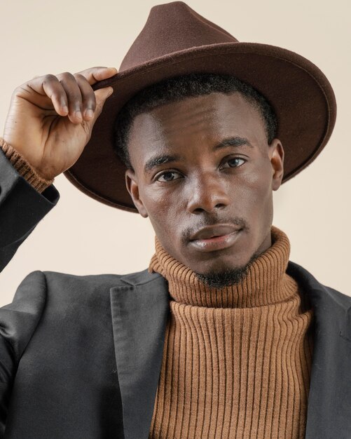 Young handsome man posing with hat