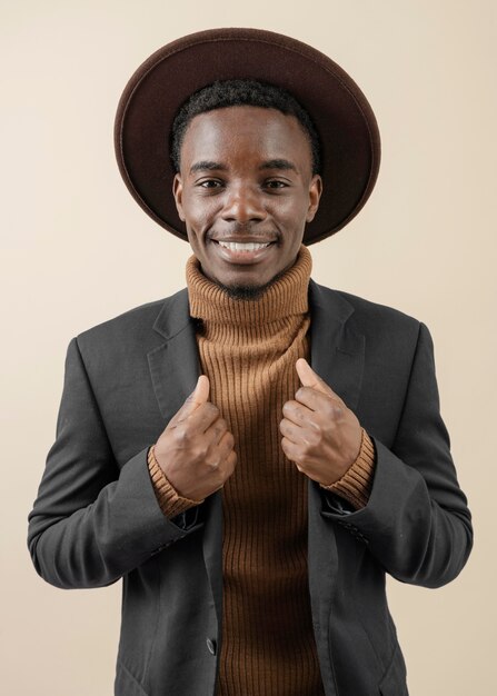 Young handsome man posing with hat