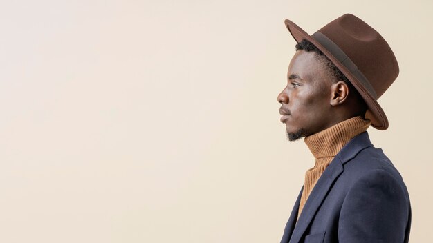 Young handsome man posing with hat