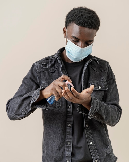 Free photo young handsome man posing with mask