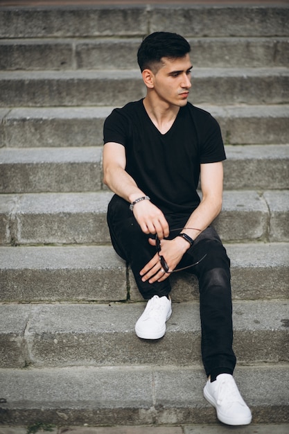 Young handsome man sitting on stairs