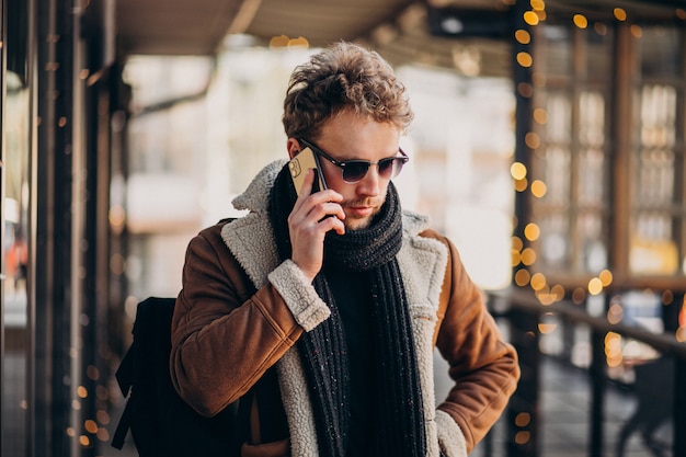 Young handsome man talking on smartphone