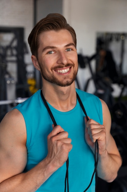 young handsome man training at the gym for bodybuilding
