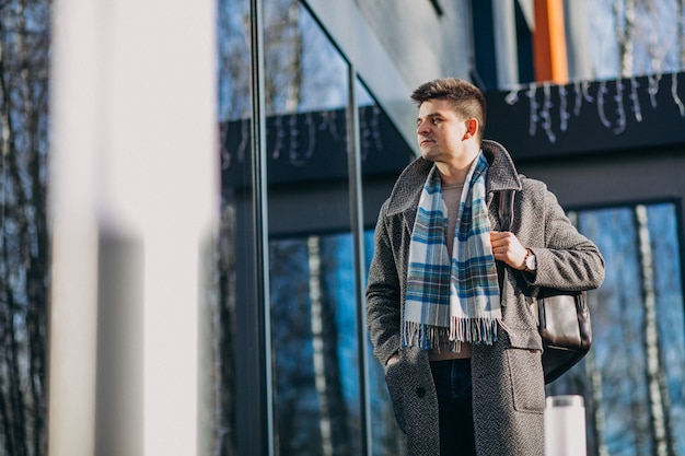 Young handsome man traveller using phone outside