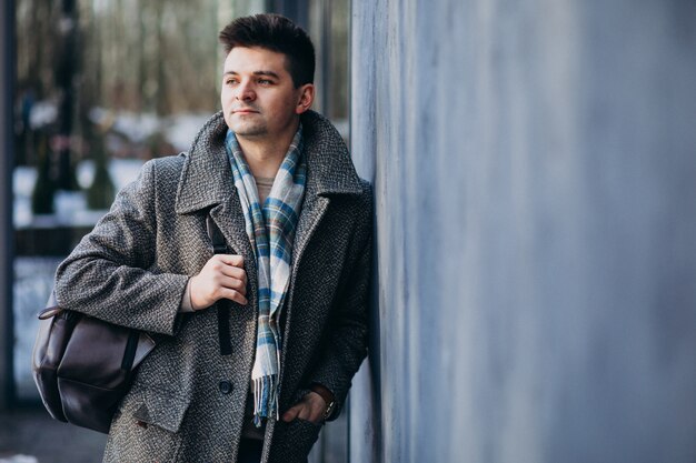 Young handsome man traveller using phone outside