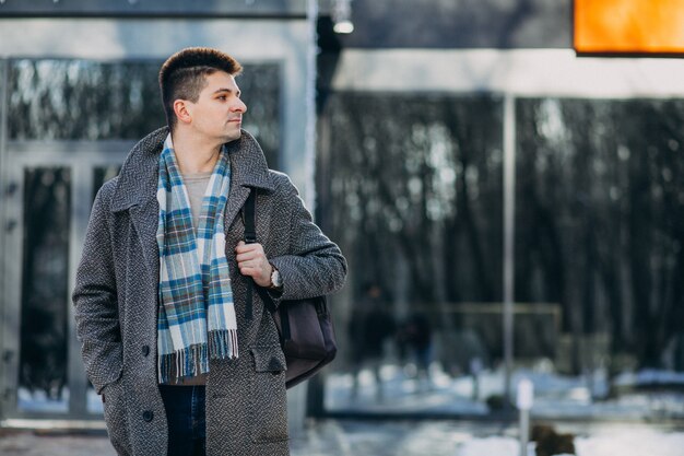 Young handsome man traveller using phone outside