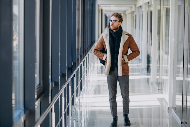 Young handsome man travelling with bag