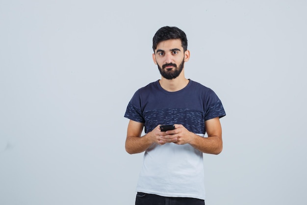 Free photo young handsome man using a phone