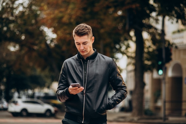 Young handsome man walking down the street