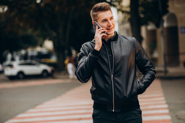 Young handsome man walking down the street