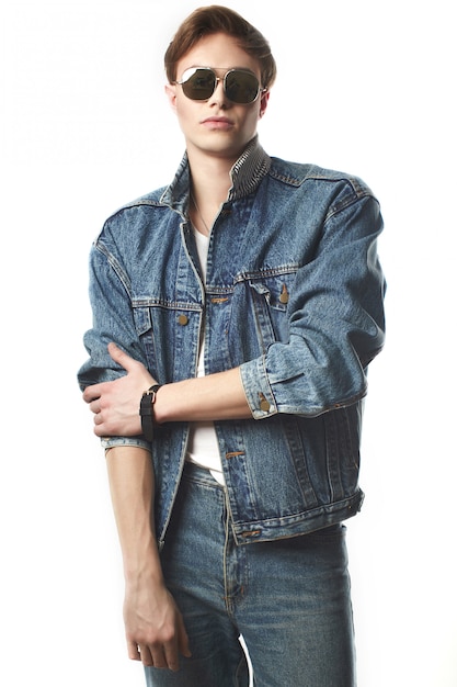 Young handsome man wearing jeans jaket in studio