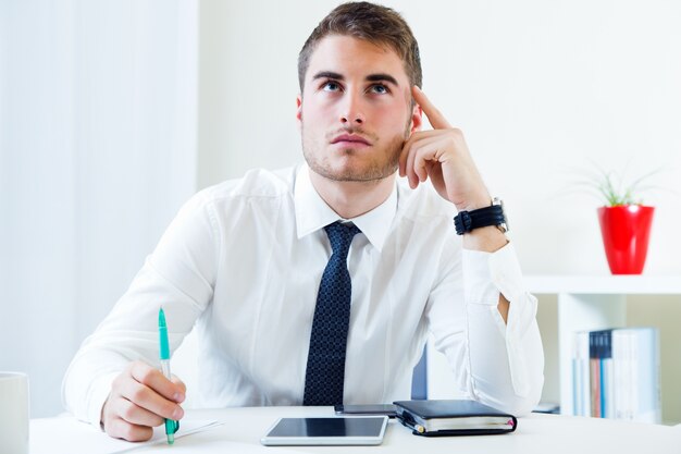 Young handsome man working in his office.