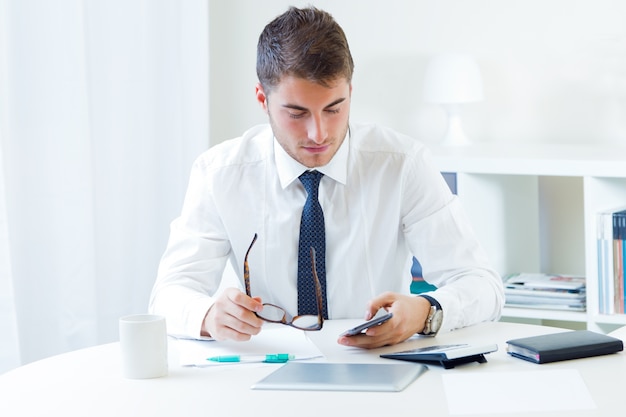 Young handsome man working in his office.