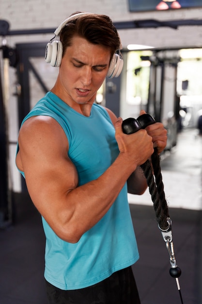 Young handsome man working out at the gym for bodybuilding