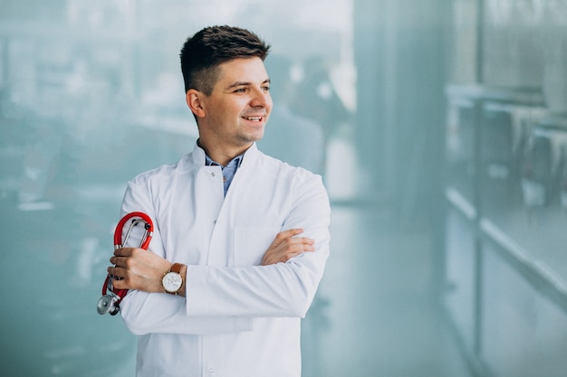 Free photo young handsome physician in a medical robe with stethoscope