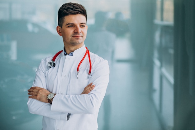 Young handsome physician in a medical robe with stethoscope