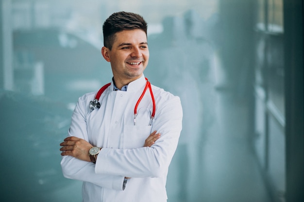 Young handsome physician in a medical robe with stethoscope