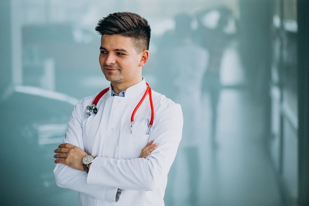 Free photo young handsome physician in a medical robe with stethoscope
