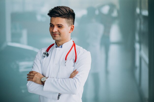 Young handsome physician in a medical robe with stethoscope