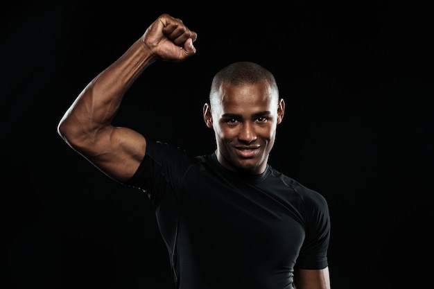 Free photo young happy afro american sports man celebrating his victory with raised arm