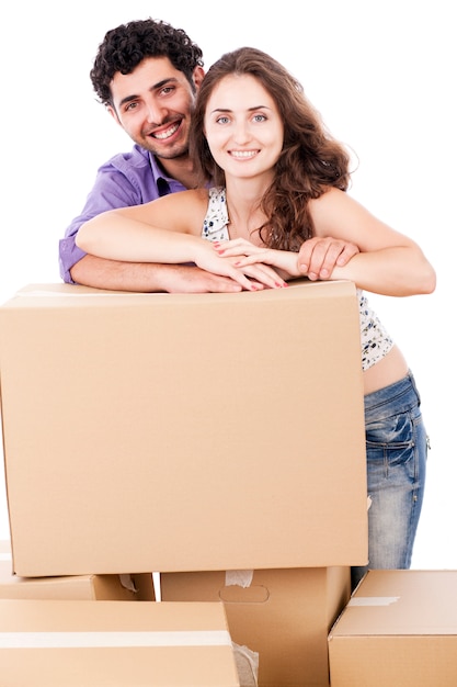 Young and happy couple are carrying boxes