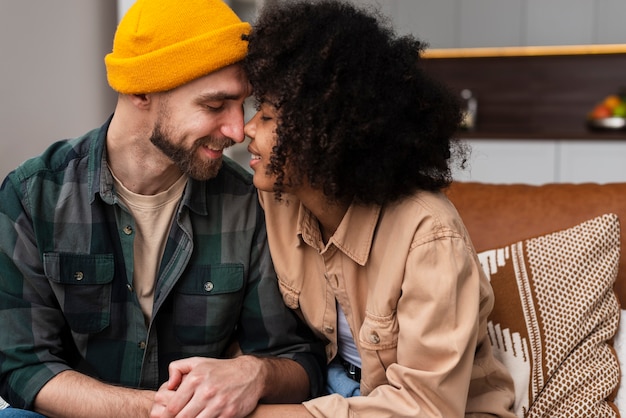 Young happy couple leaning head to head