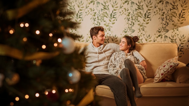 Young happy couple sitting on couch 