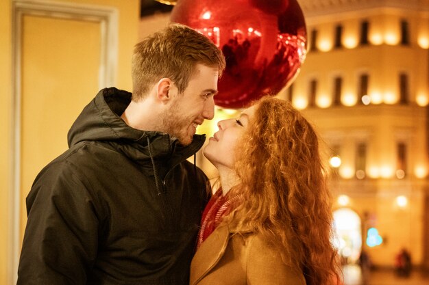 Young happy couple walking around the city in the evening