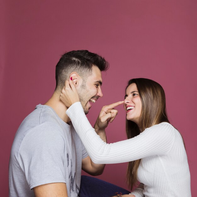 Young happy guy having fun with attractive smiling lady