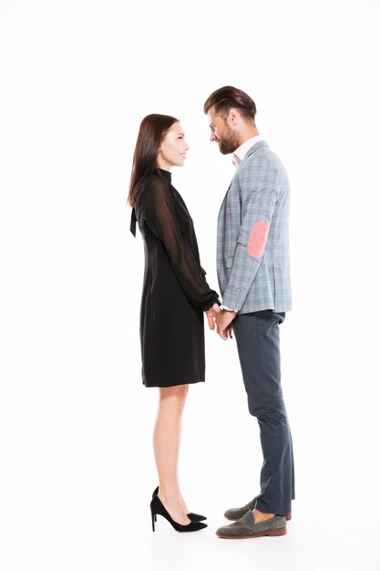 Young happy loving couple standing isolated