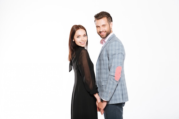 Young happy loving couple standing isolated