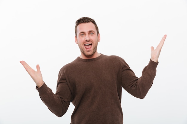 Young happy man standing isolated