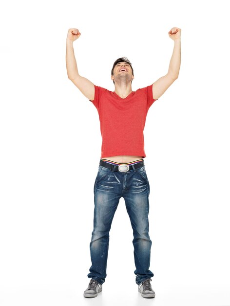 Young happy man with in casuals with raised hands up isolated on white