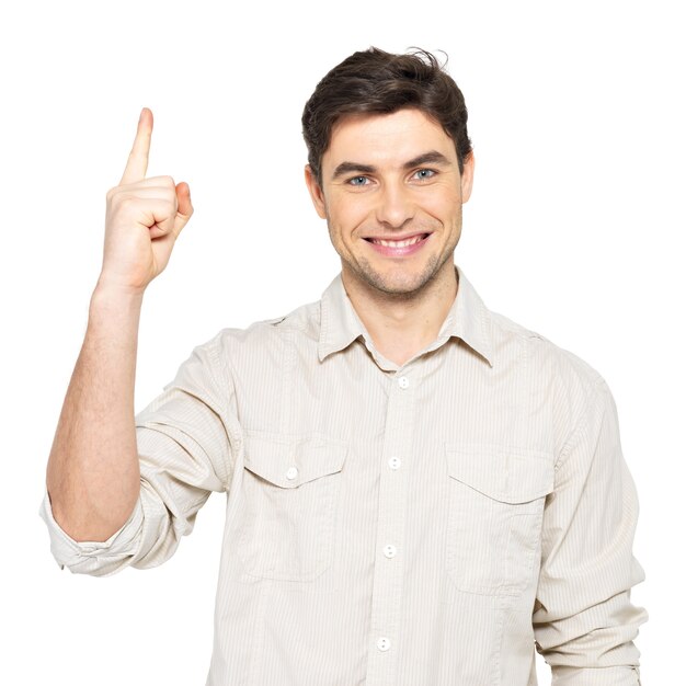 Young happy man with good idea sign  in casuals isolated on white wall.