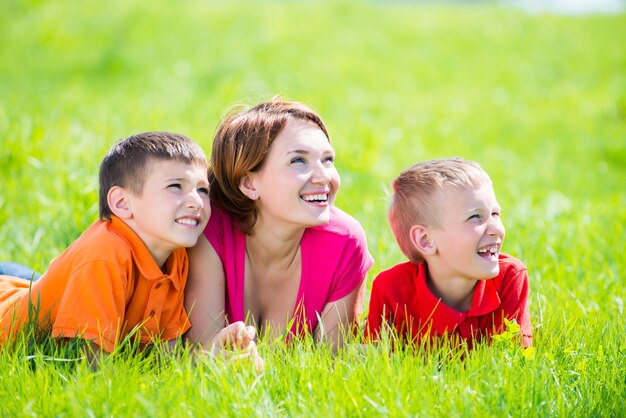 Young happy mother with children in the park