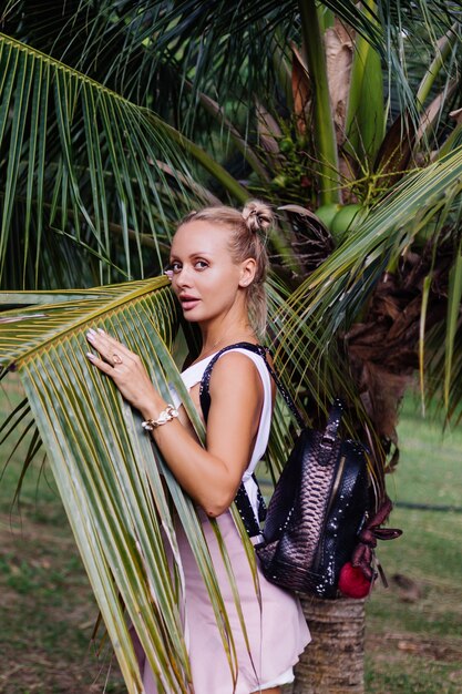 Young happy stylish woman travel posing in the nature