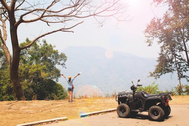 Young happy traveler with hill landscape