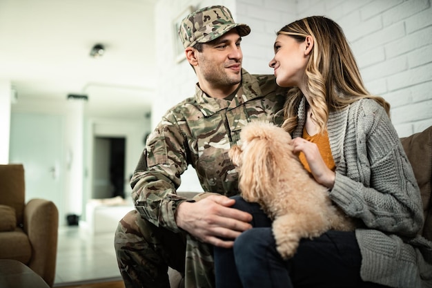 Молодой счастливый ветеран разговаривает со своей женой, возвращаясь домой с военного задания