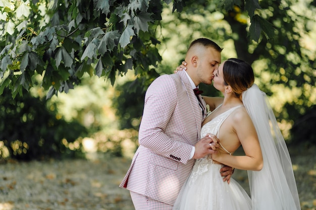 Young Happy wedding couple. Caucasian bride and groom embracing