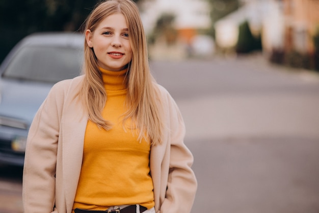 Young happy woman in beige coat