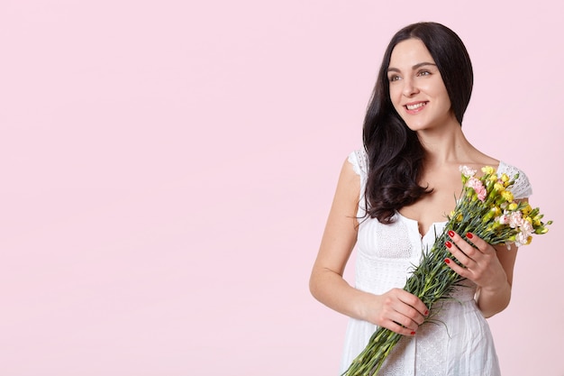 Young happy woman holding bouquet
