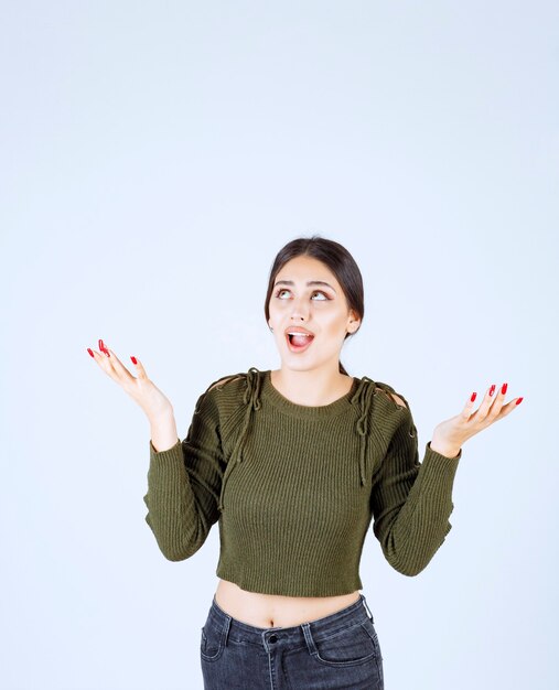 young happy woman model standing and raising her hands.