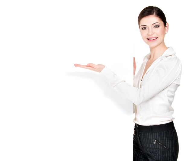 Young happy woman points on the white blank banner -  .